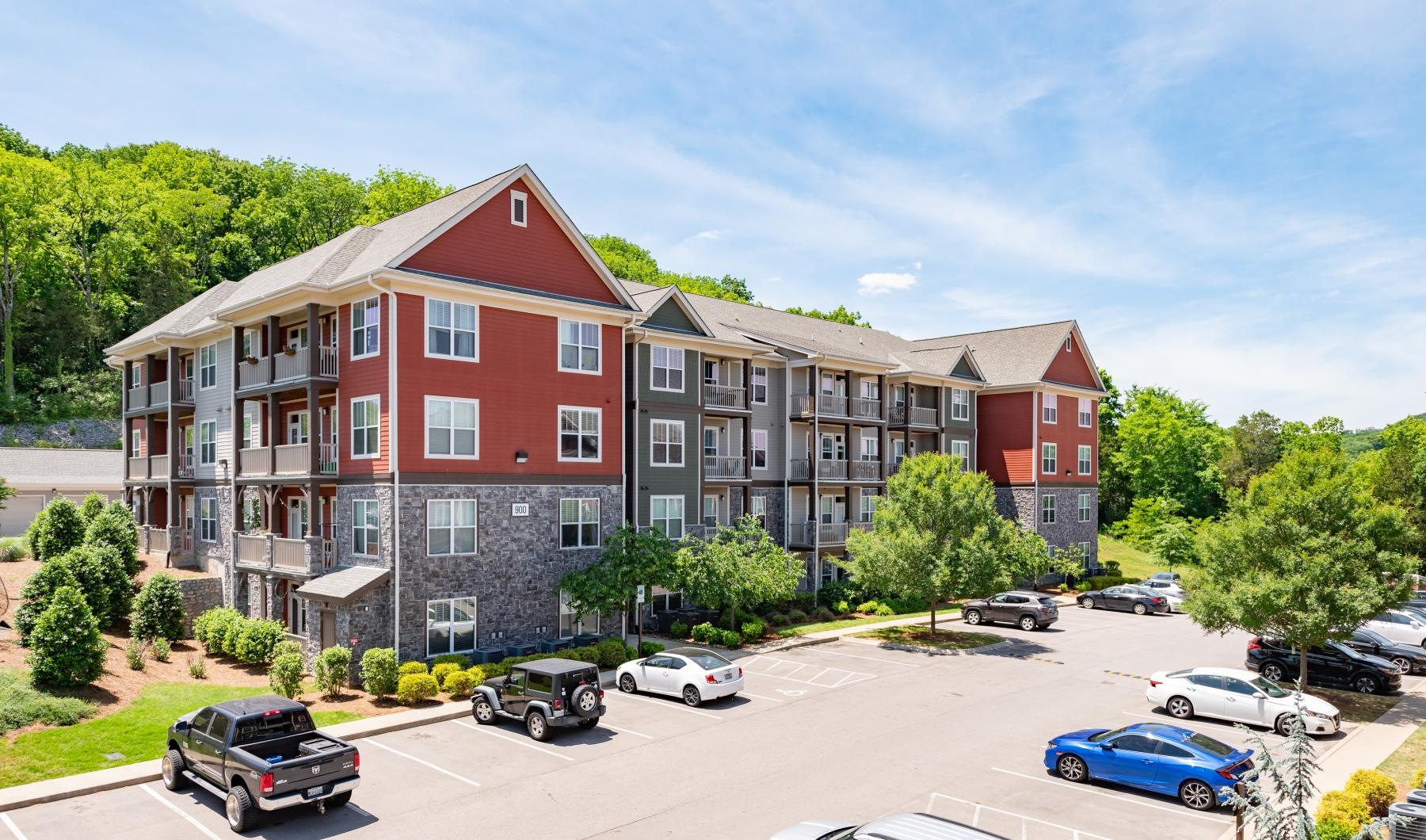 an apartment with cars in front