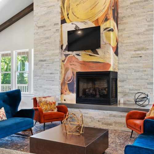 Take advantage of all The Lodge Bellevue has to offer a spacious room with a fireplace and blue chairs