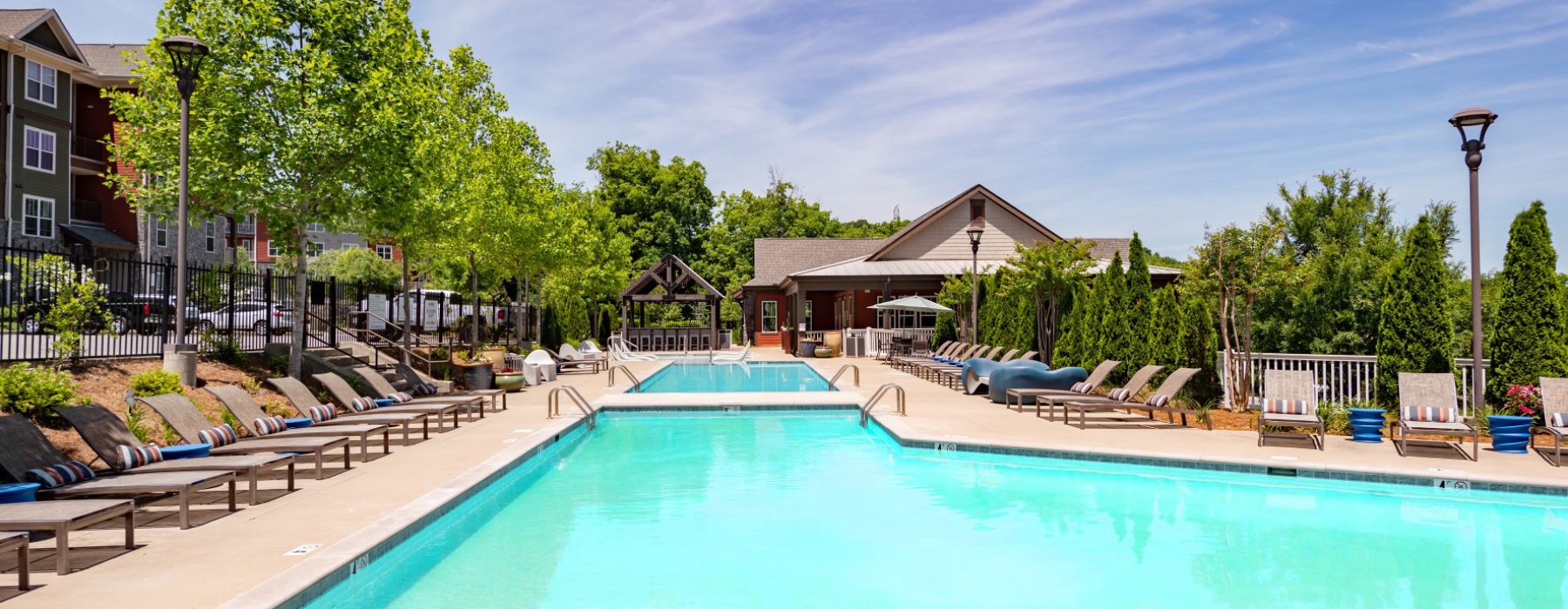 Resort-style swimming pool with lounge seating