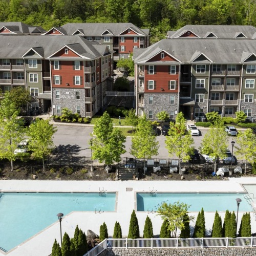 Shimmering resort-style pool apartments with trees and a swimming pool